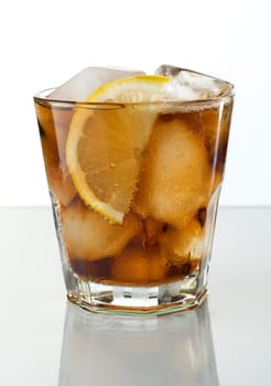 glass filled with ice and cola close up