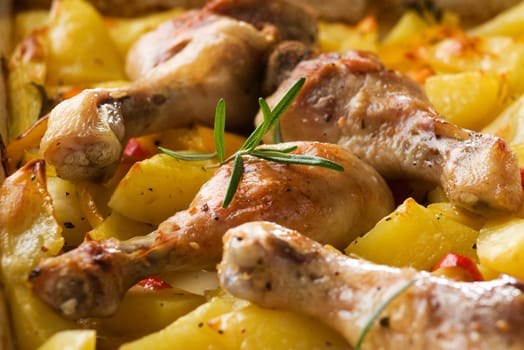 Roasted chicken with potatoes and rosemary close up