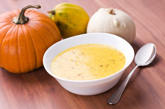 Fresh pumpkin soup with parsley close up
