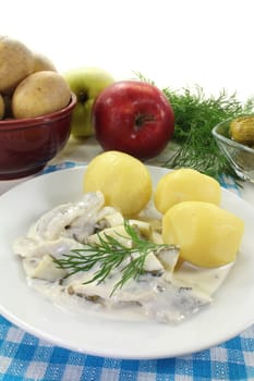 Cream herring with cucumber and jacket potatoes