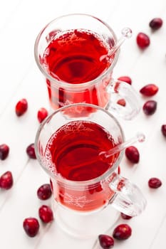 Hot drink with cranberries on white