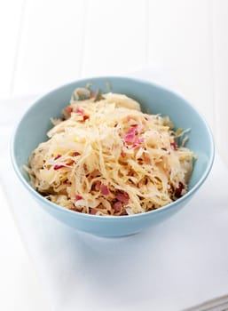 Sauerkraut - pickled cabbage in the bowl with onion