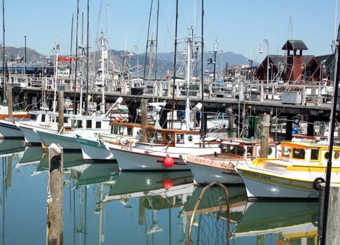 SAN FRANCISCO, CA - JUNE 13,  2008: Quaint and colorful fishing boats at popular tourist destination Fisherman's Wharf in San Francisco.
