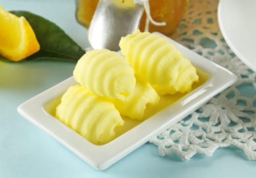 Delicate curls of butter prepared for spreading on bread.