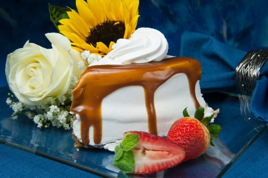 Cream cake with caramel on colored background
