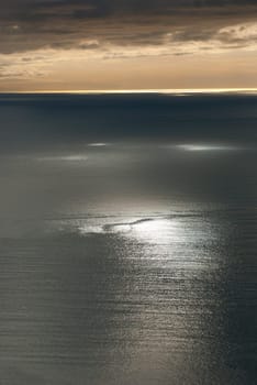 sunset with light reflections on the sea in Genoa, Italy