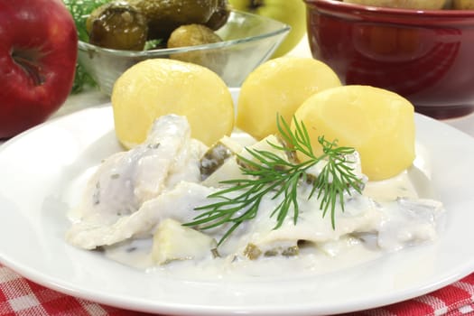 Cream herring with cucumber and jacket potatoes