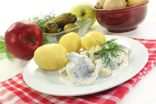 Cream herring with cucumber and jacket potatoes