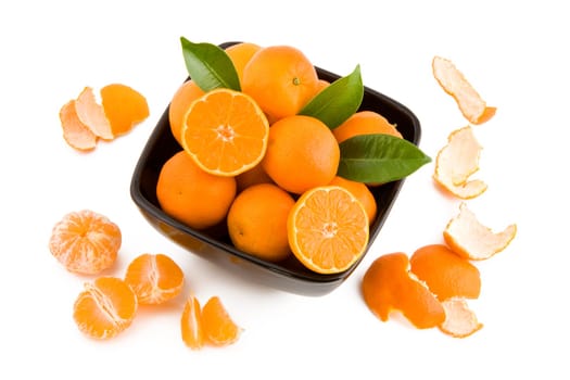 Fresh juicy tangerines in black bowl isolated on white