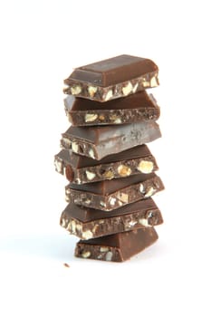 little chocolate pieces on stack closeup with copy space isolated on white background food and sweets concepts