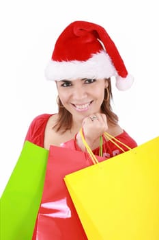Happy woman in Santa hat holding shopping bags, over a white background.