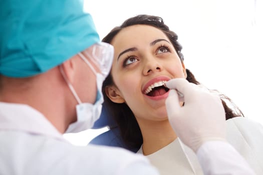 Pretty girl having mouth checkup