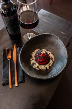 Choux Shu bun with beef, cream cheese, kim chi sauce, pepper chutney, espuma parmesan and Borodino chips. High quality photo