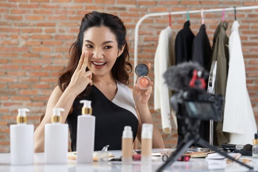 Woman influencer shoot live streaming vlog video review makeup uttermost social media or blog. Happy young girl with cosmetics studio lighting for marketing recording session broadcasting online.