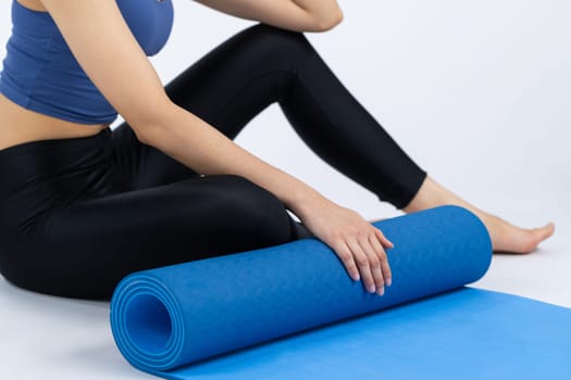 Young attractive asian woman portrait in sportswear with exercising mat. Healthy exercise and workout routine lifestyle concept. Studio shot isolated background. Vigorous