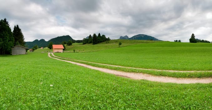 Panoramic picture in the Allgäu / Bavaria with overcast skies in summer  panoramic composed from multiple images