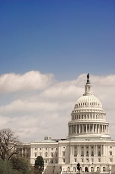Image of the Capitol dome under a blue sky and clouds in Washington D.C., United States