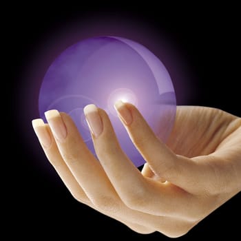 Side view of a woman's hand holding a purple crystal ball on a black background.