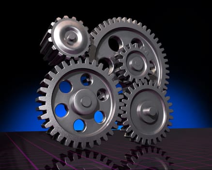 Five machine gears on a reflective surface and a dark background