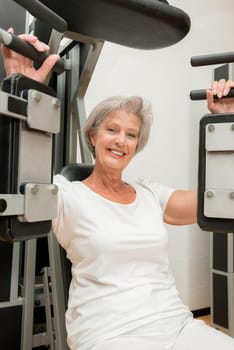 Smiling senior woman in a gym