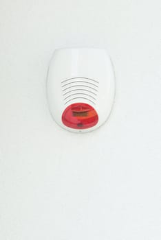 Alarm system on a white house wall