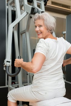 Smiling senior woman in a gym