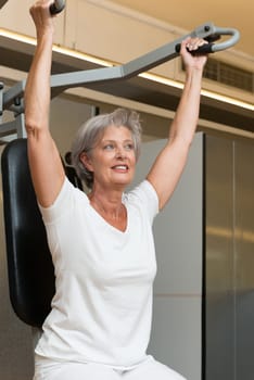 Smiling senior woman in a gym