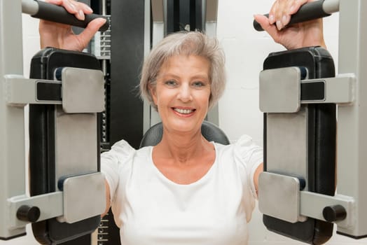Smiling senior woman in a gym