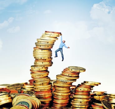 man try to climb euro coin pile