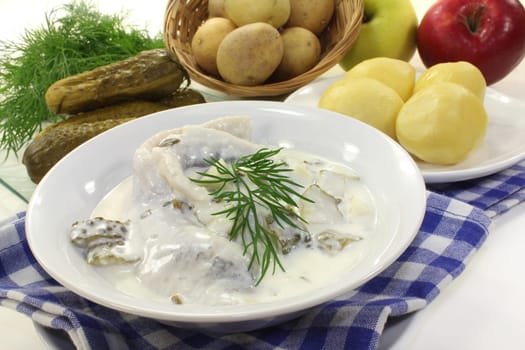 Cream herring with cucumber and jacket potatoes