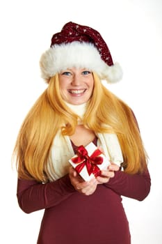 beautiful blonde woman holding a christmas gift is smiling