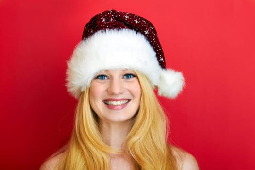beautiful blonde woman with christmas gift is smiling