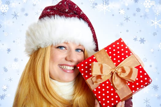 beautiful blonde woman with christmas gift is smiling