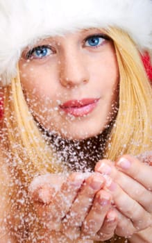 beautiful blonde woman blowing snow
