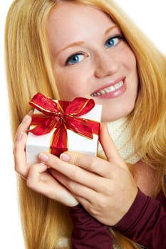 beautiful blonde woman holding a christmas gift is smiling