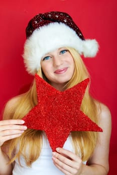 beautiful blonde girl wearing a christmas hat is smiling