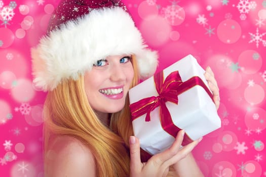 beautiful blonde woman holding a christmas gift is smiling