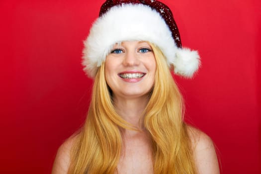 beautiful blonde woman with christmas gift is smiling