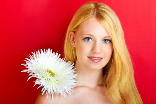 portrait of a young beautiful blonde girl with flower