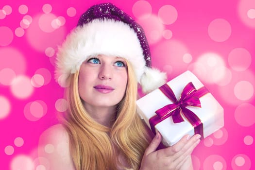 beautiful blonde woman holding a christmas gift is smiling