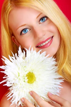 portrait of a young beautiful blonde girl with flower
