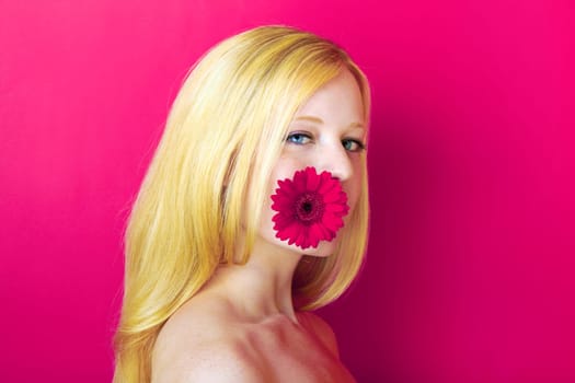 portrait of a young beautiful blonde girl with flower