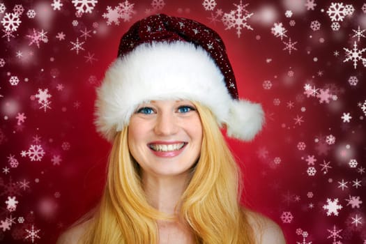 beautiful blonde woman with christmas gift is smiling