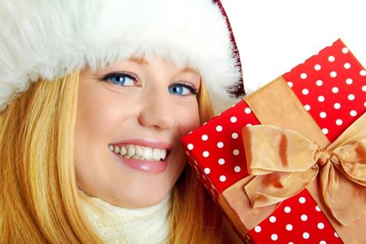 beautiful blonde woman holding a christmas gift is smiling