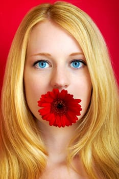 portrait of a young beautiful blonde girl with white flower