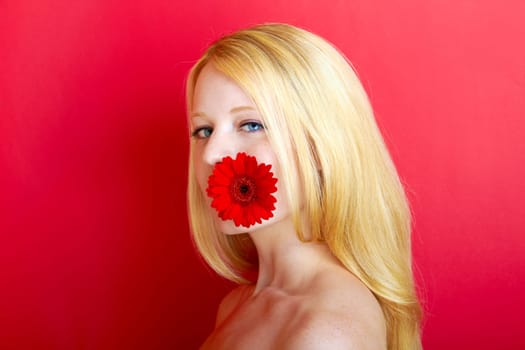 portrait of a young beautiful blonde girl with flower