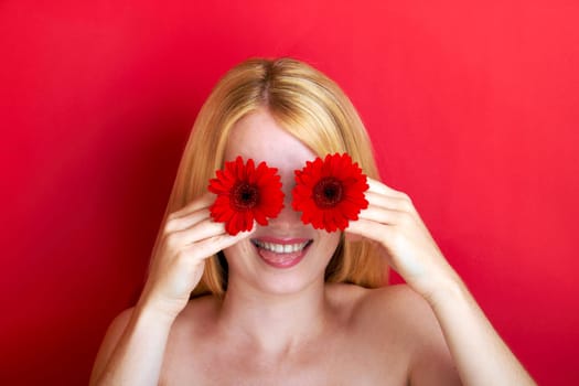 portrait of a young beautiful blonde girl with flower