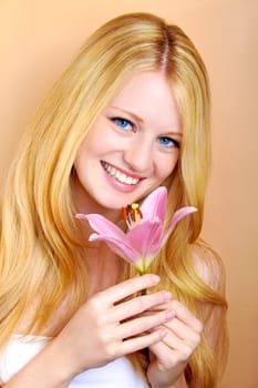 portrait of a young beautiful blonde girl with white flower
