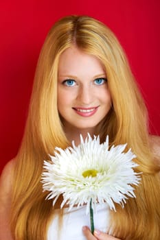 portrait of a young beautiful blonde girl with flower