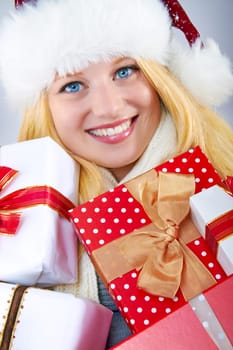 beautiful blonde woman holding a christmas gift is smiling